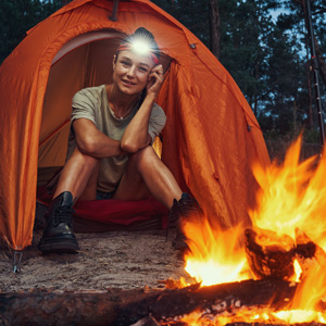 Outdoorsy girl by campfire